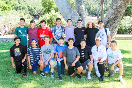 Adam Neinstein's bunk taking a group photo outside by a tree