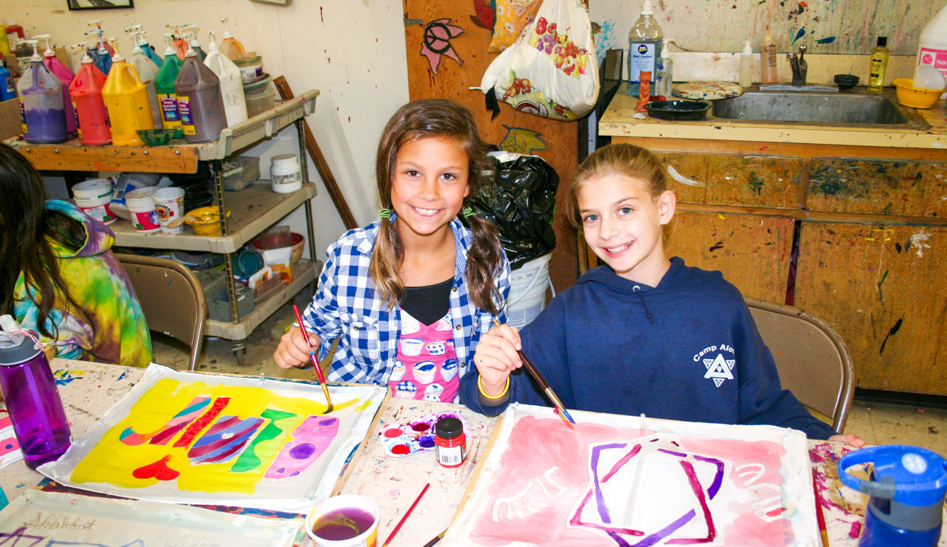 Two campers working on arts and crafts