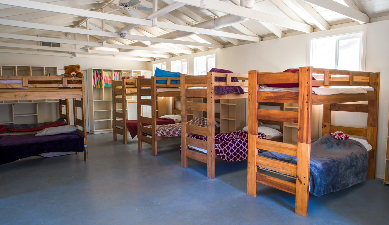 Inside of a typical bunk building with bunks