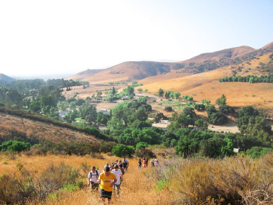 Campers walking up a hill