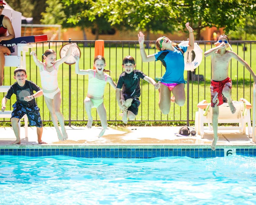 Campers jumping into the pool