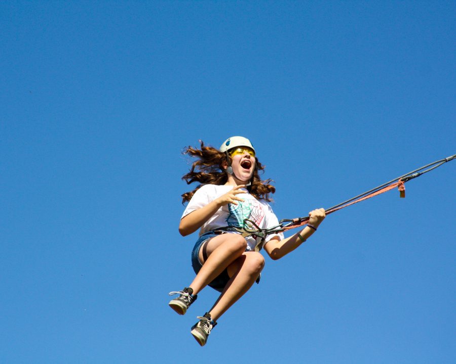 Camper swinging off of a rope