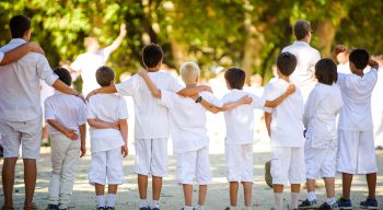 Group of campers arms on shoulders facing back to camera