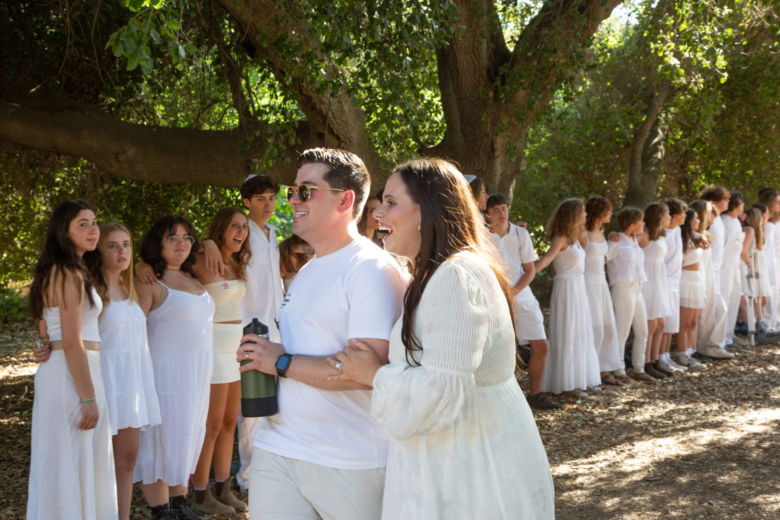 a married couple in their mid twenties walking down a path made by the CITs